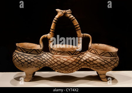 Ancient Greek Cypriot composite terracotta vessel with three joined bowls, dynamic basket handle, Middle Bronze Age, circa 1900–1650 B.C. Stock Photo