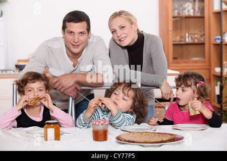 Young family having breakfast Stock Photo