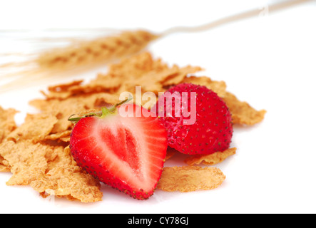 Crispy bran flakes with strawberries and a stalk of wheat Stock Photo