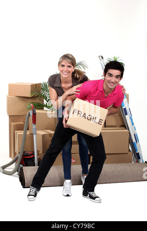 Playful couple moving house Stock Photo