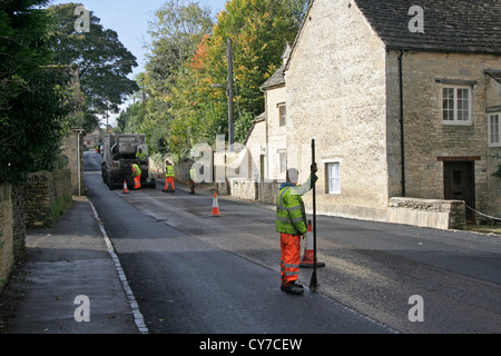 Resurfacing the road at Bibury Gloucestershire Stock Photo