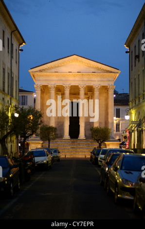 The Maison Carrée or Roman Temple Lit at Night or at Dusk Nimes Gard France Stock Photo
