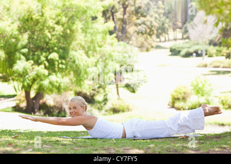 Side view of a smiling woman doing her exercises in the park Stock Photo
