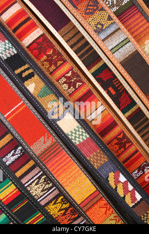 Handmade, colorful belts in an abstract variety of styles, colors and patterns in the outdoor craft market in Cotacachi, Ecuador Stock Photo