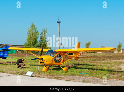 Light airplane for cruising and training on yellow colour - general view. Stock Photo