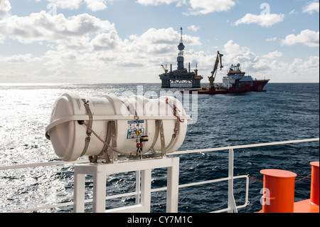 Offshore Rig Life Raft Live raft with oil rig and supply boat in the background on the North ...