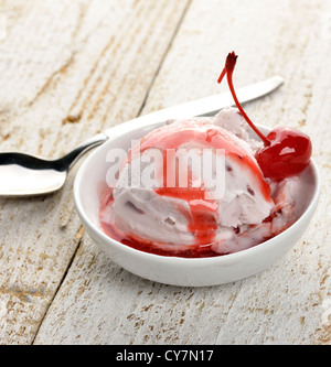 Vanilla And Cherry Ice Cream On A Wooden Table Stock Photo