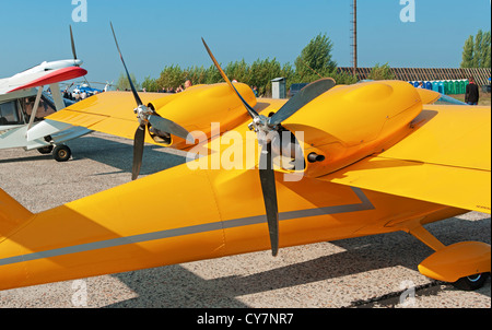 Light two-engine airplane for cruising and training on yellow colour - engine view. Stock Photo