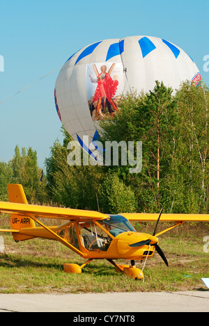 Light airplane for cruising and training on yellow colour - general view. Stock Photo