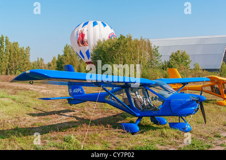Light airplane for cruising and training on blue colour - general view. Stock Photo
