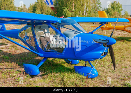 Light airplane for cruising and training on blue colour. Stock Photo