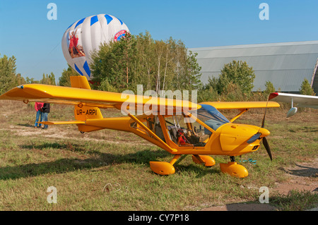 Light airplane for cruising and training on yellow colour. Stock Photo