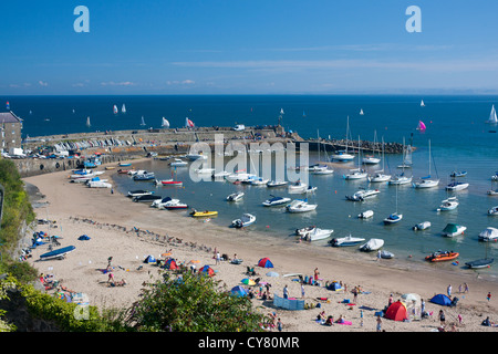 New Quay Harbour and beach with regatta beyond jetty wall Ceredigion Mid Wales UK Stock Photo