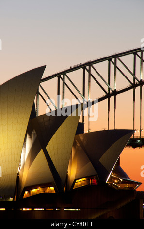 Close-up of Sydney Opera House and Harbour Bridge at dusk with pink sunset sky Harbour Bridge Climbers in shot Sydney Australia Stock Photo