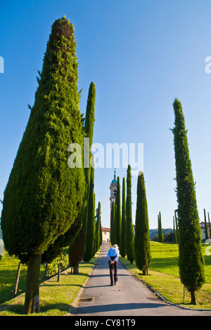 ALLEY OF CYPRESSES, SANT ABBONDIO CHURCH IN GENTILINO, NEAR MONTAGNOLA, LUGANESE, TICINO, SWITZERLAND Stock Photo