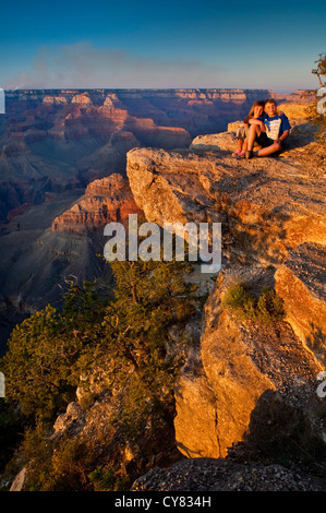 Kids on rock at Sunset at Yavapai Point, South Rim, Grand Canyon National Park, Arizona Stock Photo