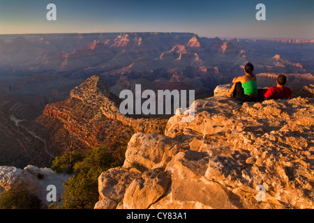 Tourist couple watching the sunset from Grandview Point, South Rim, Grand Canyon National Park, Arizona Stock Photo
