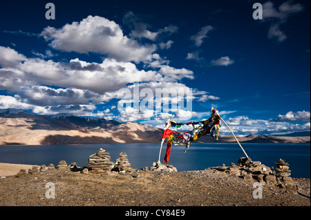 Sunset view at Tso Moriri Lake, Stone pyramid and Buddhist praying flags. Himalaya mountains landscape. Inddia, Ladakh, 4600m Stock Photo