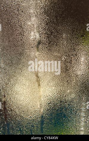 condensation collecting on the inside of window creating abstract patterns interaction of light and form from vase Stock Photo