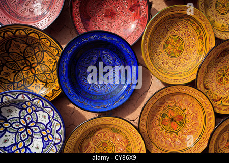 ornate traditional geometric artwork designs painted and glazed on pottery and plates in the Atlas Mountains, Morocco Stock Photo