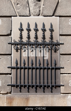 Wrought iron blind window antique ornate grille with finials. Stock Photo