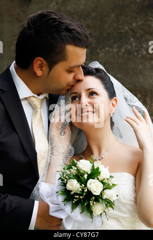 Newly-married couple in park Stock Photo