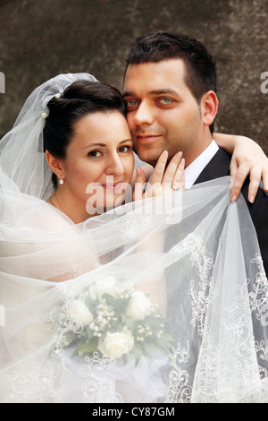 Newly-married couple in wedding clothes in park Stock Photo