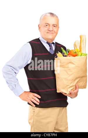 A gentleman holding a paper bag full of food isolated on white background Stock Photo