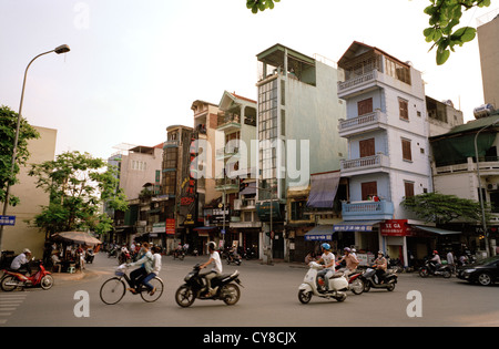Urban traffic and street life in Hanoi in Vietnam in Far East Southeast Asia. City Cities Street Scene People Scooter Vespa Transport Travel Stock Photo