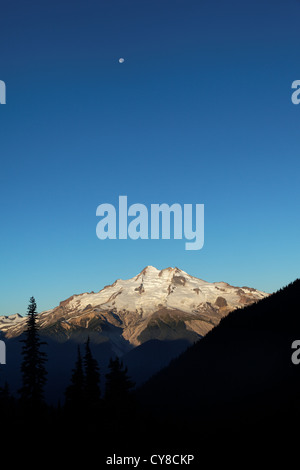 Moon over Glacier Peak viewed from Buck Creek Pass, Cascade Mountains, Snohomish County, Washington Stock Photo