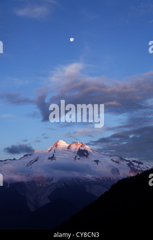 Moon over Glacier Peak viewed from Buck Creek Pass, Cascade Mountains, Snohomish County, Washington Stock Photo