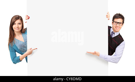 Man and female posing behind a blank panel isolated on white background Stock Photo