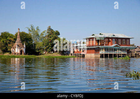 Myanmar, Burma. Old Stupa and Village House on Stilts, Inle Lake, Shan State. Stock Photo