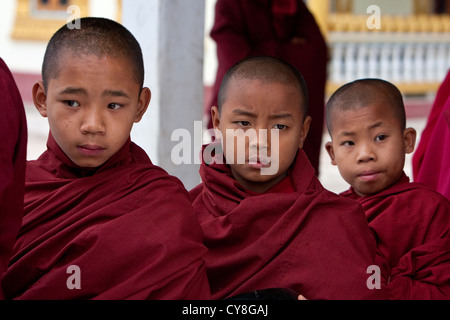 Myanmar, Burma. Three Young Boy Buddhist Monks, Alodaw Pauk Pagoda, Nampan Village, Inle Lake, Shan State. Stock Photo