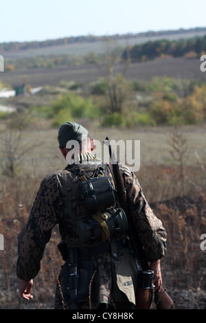 reactors in uniform SS soldiers going in the field, away from the camera Stock Photo