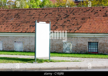 Blank billboard on the autumn very old Europian cities street. Contains billboard area patch Stock Photo