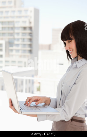 Young happy woman uses laptop computer in internet cafe Stock Photo - Alamy