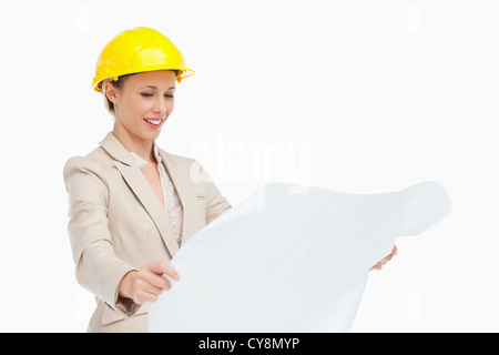 Smiling woman in a suit looking at plans Stock Photo
