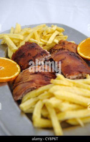 Leitão assado - traditional Portugal Bairrada region roasted piglet with french fries and orange Stock Photo