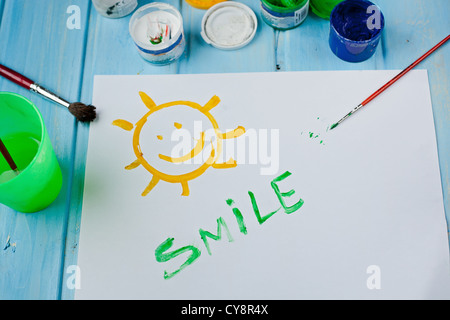 Kids drawing on white sheet of paper with crayons and markers on wooden  table, closeup Stock Photo - Alamy