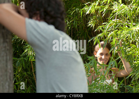 Young woman playing hide-and-seek Stock Photo