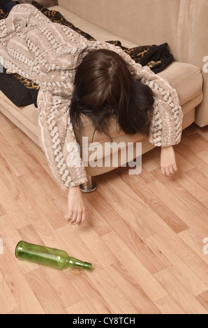 drunk woman sleeping on the sofa Stock Photo