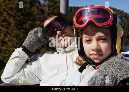 Brother and younger sister on chair lift, portrait Stock Photo