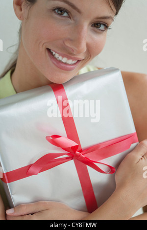 Young woman portrait holding gift Stock Photo - Alamy