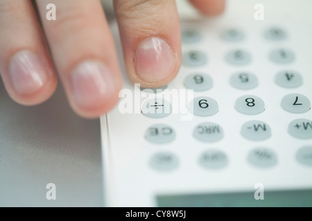 Woman using calculator, extreme close-up Stock Photo