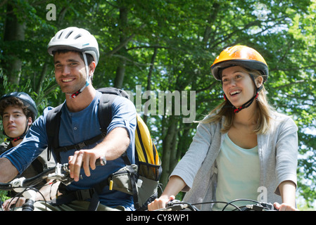 Young cyclists riding in woods Stock Photo