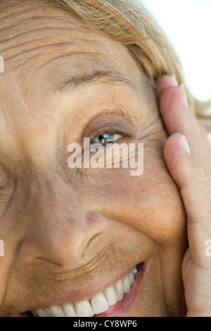 Senior woman smiling, close-up portrait