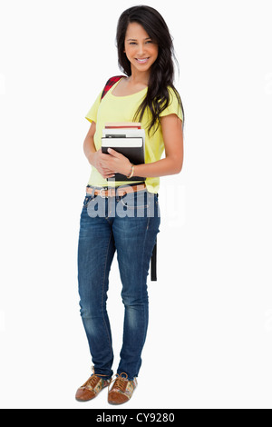 Portrait of a beautiful woman student with backpack holding textbooks Stock Photo