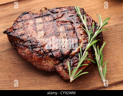 Beef steak on a wooden table. Stock Photo