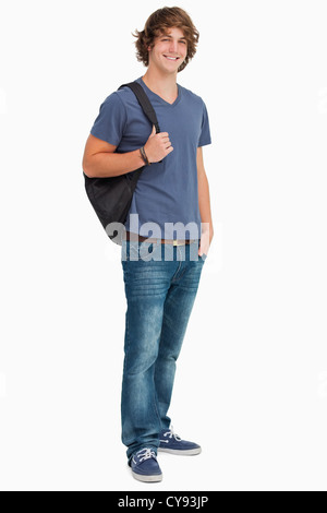 Smiling male student with backpack holding books and showing his biceps ...